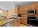 Bright kitchen featuring granite countertops, wood cabinets, and stainless steel appliances at 1825 Brittlebush Ln, Johns Island, SC 29455