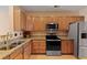 Well-equipped kitchen with granite countertops, stainless steel appliances, and wood cabinets at 1825 Brittlebush Ln, Johns Island, SC 29455