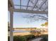 Scenic lake view framed by a pergola, showcasing waterfront homes and palm trees in the distance at 1825 Brittlebush Ln, Johns Island, SC 29455