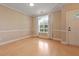 Bright living room featuring hardwood floors, a large window, neutral paint, and a white front door at 1825 Brittlebush Ln, Johns Island, SC 29455