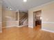 Spacious living area with hardwood floors, view to the carpeted staircase and an entry to the kitchen at 1825 Brittlebush Ln, Johns Island, SC 29455