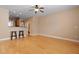 Open living area with hardwood floors, neutral walls, and a breakfast bar with seating at 1825 Brittlebush Ln, Johns Island, SC 29455