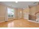 Inviting living room with beautiful hardwood floors, a staircase, neutral paint, and a sunlit window at 1825 Brittlebush Ln, Johns Island, SC 29455