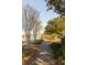 Scenic path alongside tranquil lake with a covered dock, offering a picturesque setting for leisurely walks and nature appreciation at 1825 Brittlebush Ln, Johns Island, SC 29455