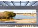 Scenic view of a serene lake framed by a charming pergola, offering a tranquil and picturesque setting at 1825 Brittlebush Ln, Johns Island, SC 29455