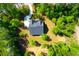Aerial shot of a new home surrounded by vibrant trees with a long driveway at 202 Countryside Way, Summerville, SC 29483
