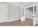 Elegant bedroom featuring hardwood floors, neutral walls, staircase, and glass panel doors at 202 Countryside Way, Summerville, SC 29483