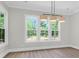 Dining room featuring large windows with wooded exterior views and modern lighting at 202 Countryside Way, Summerville, SC 29483