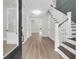 Inviting home entryway with hardwood floors and a staircase featuring elegant white railings at 202 Countryside Way, Summerville, SC 29483