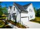 Bright, white, modern farmhouse featuring beautiful landscaping and a driveway at 202 Countryside Way, Summerville, SC 29483