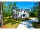 Beautiful two-story home with a charming exterior and a winding driveway through lush greenery at 202 Countryside Way, Summerville, SC 29483