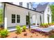 Charming front porch and beautiful landscaping featuring colorful flowers, manicured shrubs, and pine straw at 202 Countryside Way, Summerville, SC 29483