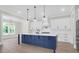 Chef's kitchen boasts a large island, stainless appliances, and custom cabinetry for all your cooking needs at 202 Countryside Way, Summerville, SC 29483