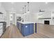 Modern kitchen features a large center island with dark blue cabinetry and open layout to the living room at 202 Countryside Way, Summerville, SC 29483