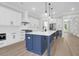 Modern kitchen with white cabinets, stainless appliances and a large island with pendant lighting at 202 Countryside Way, Summerville, SC 29483