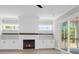 Bright living room features built-in cabinets, a fireplace, and sliding glass doors to the exterior at 202 Countryside Way, Summerville, SC 29483