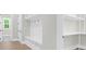 Mudroom with custom storage, bench and coat hooks leading into a hallway with tile floors at 202 Countryside Way, Summerville, SC 29483