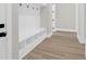 Close up of mudroom area with coat hooks and storage and view of wood-look floors at 202 Countryside Way, Summerville, SC 29483