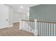 Staircase with white rails and wood treads leads to a landing with panelled wall at 202 Countryside Way, Summerville, SC 29483