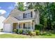 Charming two-story home featuring a well-kept lawn, attached garage, and welcoming front porch at 206 Trickle Dr, Summerville, SC 29483