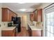 Galley kitchen with stainless steel appliances, warm wood cabinets, and lots of counter space at 206 Trickle Dr, Summerville, SC 29483