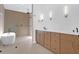 Bright bathroom features a modern soaking tub, a walk-in shower, and double vanity with sleek fixtures at 2151 River Road, Johns Island, SC 29455