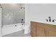 Bathroom with a glass-enclosed shower over tub, neutral tile, and wood vanity with white countertop at 2151 River Road, Johns Island, SC 29455