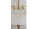 Modern bathroom sink with white marble countertop and gold colored faucet at 2151 River Road, Johns Island, SC 29455