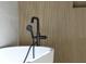 Modern bathroom featuring a white bathtub and a black faucet fixture at 2151 River Road, Johns Island, SC 29455