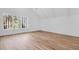 Bright bedroom with vaulted ceiling, hardwood floors, and large windows with wooded views at 2151 River Road, Johns Island, SC 29455