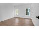 Bright bedroom with wood floors, white walls, and two windows bringing in plenty of natural light at 2151 River Road, Johns Island, SC 29455