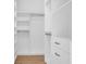 Bright closet with white cabinets and gold hardware to maximize storage space at 2151 River Road, Johns Island, SC 29455