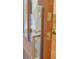 Close up of a door handle with gold hardware on a wood door at 2151 River Road, Johns Island, SC 29455