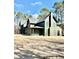 An exterior view of a large home with a dark roof on a sunny day at 2151 River Road, Johns Island, SC 29455