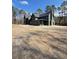 View of a stately green home with a dark roof and chimney surrounded by tall trees at 2151 River Road, Johns Island, SC 29455