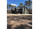 Dark painted two-story home with sleek design, visible architectural details, and situated on a spacious lot at 2151 River Road, Johns Island, SC 29455