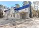 Back exterior of a two-story white home surrounded by trees at 2151 River Road, Johns Island, SC 29455