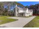 Stately two-story home with white exterior, gabled roof, and circular driveway at 2151 River Road, Johns Island, SC 29455