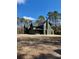 View of an expansive dark green home with a chimney surrounded by trees at 2151 River Road, Johns Island, SC 29455