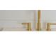 Close-up of elegant, gold faucet with marble countertop at 2151 River Road, Johns Island, SC 29455