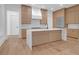 Modern kitchen featuring a central island with a waterfall countertop at 2151 River Road, Johns Island, SC 29455