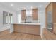 Modern kitchen boasts wood cabinets, stainless appliances, and a large island with white countertop at 2151 River Road, Johns Island, SC 29455