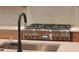 Stainless steel stove with six burners and marble backsplash for a modern kitchen look at 2151 River Road, Johns Island, SC 29455