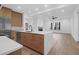 Open kitchen with wooden cabinets, stainless steel appliances, and island overlooking living area at 2151 River Road, Johns Island, SC 29455