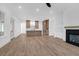 Open-concept living space with hardwood floors, fireplace, and modern kitchen with island at 2151 River Road, Johns Island, SC 29455