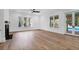 Living room with hardwood floors, fireplace, and doors to outdoor pool area at 2151 River Road, Johns Island, SC 29455