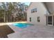 Backyard pool surrounded by stone tiles and lush landscaping with a view of the house at 2151 River Road, Johns Island, SC 29455