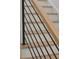 Modern staircase featuring black metal railing and light wood handrail at 2151 River Road, Johns Island, SC 29455