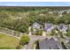 Aerial view of a quaint neighborhood featuring a manicured yard, mature trees, and proximity to a wooded area at 2197 Sandy Point Ln, Mount Pleasant, SC 29466