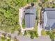 Aerial view of the house, showcasing its roof, driveway, backyard with trampoline, and proximity to neighboring houses at 2197 Sandy Point Ln, Mount Pleasant, SC 29466